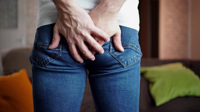 4K video footage of a middle aged man has pain in the butt, Hemorrhoids, Anal disorders. 