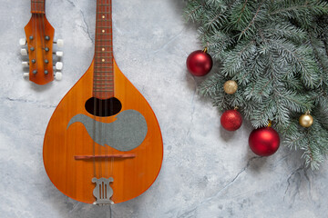 Old mandolin and fir-tree branches with Christmas decor. Christmas and New Year's concept. Top...