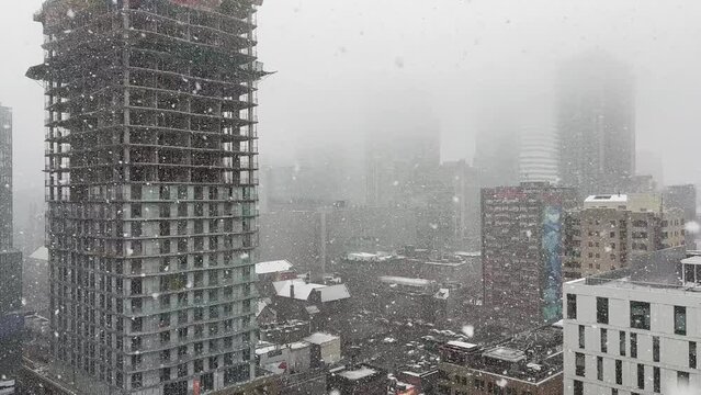 Building under construction in heavy snowfall during winter day