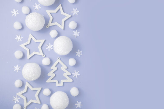 Christmas pattern border. Stars, balls, white Christmas trees on a purple pastel background