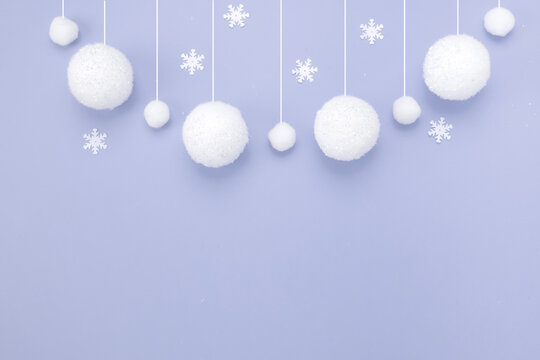 Christmas composition, winter background, snowfall from white balls, blue background.