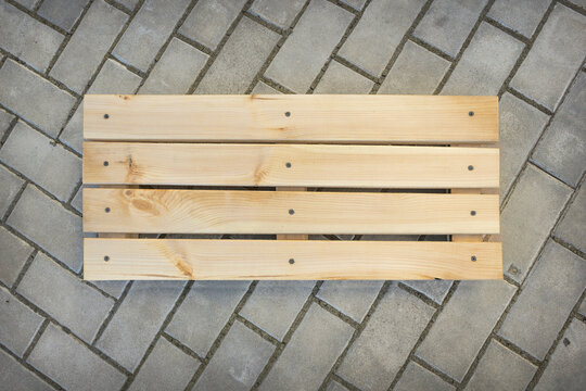 Lattice made of wooden planks on stone floor
