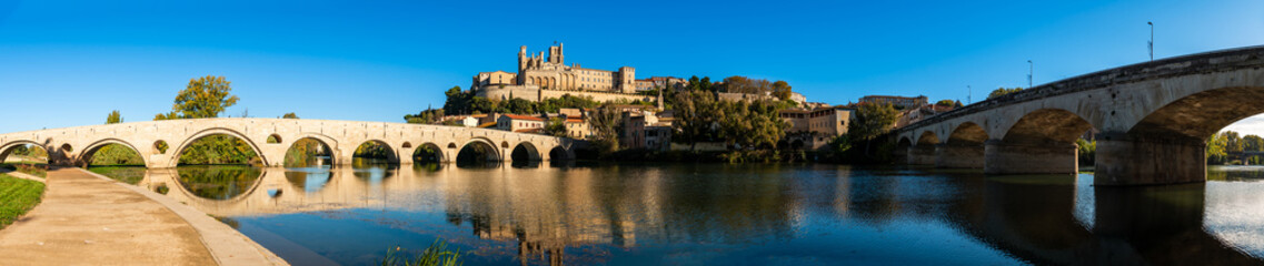 Fototapeta na wymiar Old bridge over the Orb river and Saint Nazaire cathedral in Béziers, Hérault, Occitanie, France