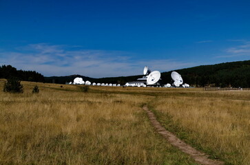 Plana Earth Satellite Station or Geodetic Observatory, against the background of coniferous...