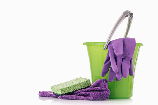 Household Cleaner Tools And Sundry Items Spring Cleaning Kitchen, Bathroom And Other Rooms. On White. Cleaning And Janitorial Service Concept. Green And Vibrant Violet. Bucket With Gloves And Dusters