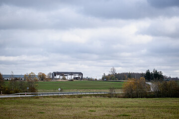 Abandoned remains of a broken barn in a field in Latvia in autumn