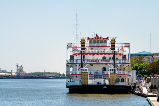 Savannah, USA - May 11, 2018: Old town downtown River street waterfront with Georgia Queen steamboat cruise ship belles ferry sign in southern town city