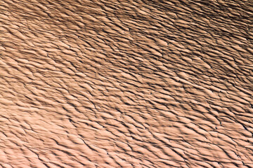 Relief representation of a rippled abstract surface in beige color