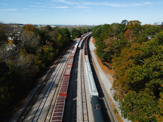 Obraz na płótnie Canvas Aerial of train on tracks in autumn