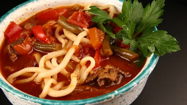 Traditional dish with noodles. Lagman. On a dark background. Selective focus.
