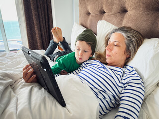 Mother and son watching movie on digital tablet
