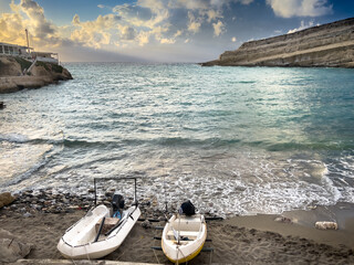 Boats moored at shore and scenic view of seascape