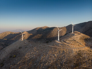 Wind turbines on mountain during sunset