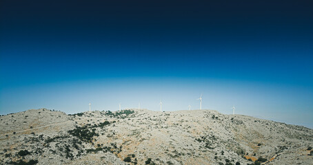 Distant view of wind turbines on mountain