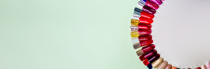 Nail polish samples in different bright colors. Colorful nail lacquer manicure swatches. Top view of nail art wheel palette. bright nail polishes.Nail art design wheel.copy space