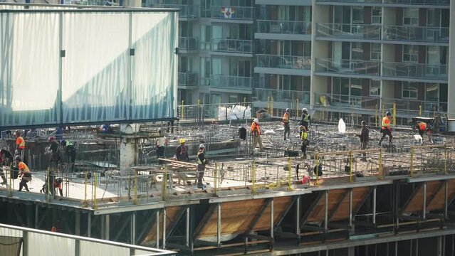 Workers at top of building at construction site