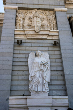 Madrid, Spain - July 10, 2022: A Carrara Marble Statue Of Angel San Rafael At The Facade Of Almudena Cathedral, Sculpted By Marco Augusto Dueñas