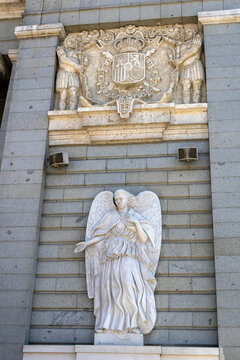 Madrid, Spain - July 10, 2022: A Carrara marble statue of angel Azrael at the facade of Almudena Cathedral, sculpted by Marco Augusto Due&ntilde;as