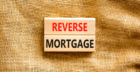 Reverse mortgage symbol. Concept words Reverse mortgage on wooden blocks. Beautiful canvas table canvas background. Business and reverse mortgage concept. Copy space.