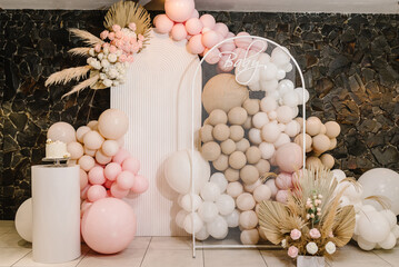 Birthday decorations - balloons, garland and decor for little baby party on a wall background....