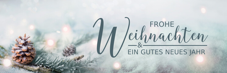 Christmas greeting card German text - Frohe Weihnachten und ein gutes neues Jahr - Pine cones and fir branches in winter snow landscape with magic lights in background -  Panorama, banner. - 544972398