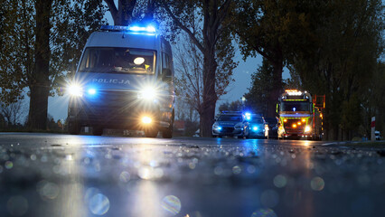 Służby ratunkowe policja, straż i pogotowie podczas akcji ratunkowej wypadku samochodowego.