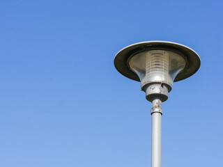 Lamppost with copy space on clear sky - Consumption of light concept