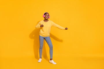 Fototapeta na wymiar Full length body size view of attractive cheerful girl meloman listening rock hit dancing isolated over bright yellow color background
