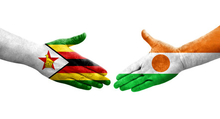 Handshake between Niger and Zimbabwe flags painted on hands, isolated transparent image.