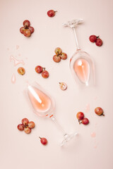 Two glasses of rose wine on a pink background.