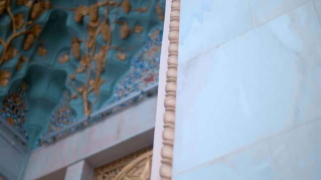 Beautiful colorful elements on cultural famous oriental architectural buildings with floral pattern of ceramic tiles, arches, columns, which stand out with volumetric textures and national style