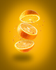 Flying juicy orange on an orange background. Isolated object on background. A splash of orange juice. Ripe juicy yellow orange.