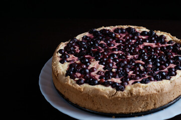 freshly baked berry pie on dark background, close-up, dessert with fresh fruit, hot, steaming