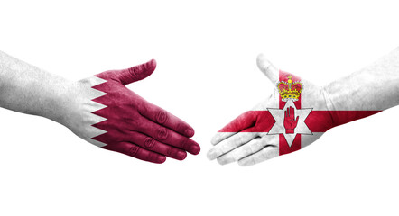 Handshake between Northern Ireland and Qatar flags painted on hands, isolated transparent image.