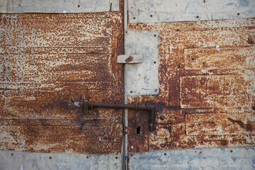 corrosion of old rusty gate, brown and grey bolt