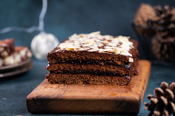 Traditional polish dessert piernik, pryanik or sponge cake with spices and honey. Rectangular piece of brown cocoa tart, gingerbread or layer biscuit. Polish christmas dessert