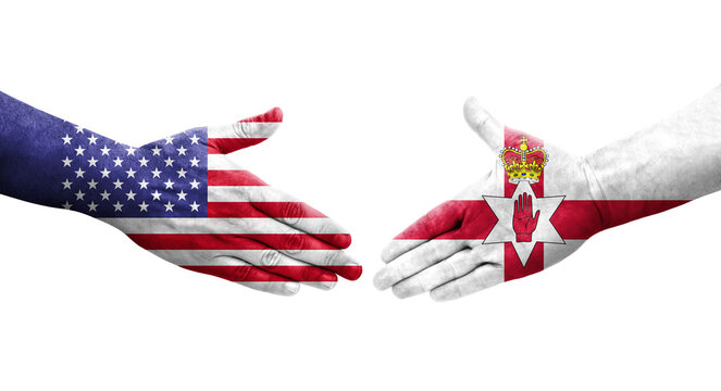 Handshake between Northern Ireland and USA flags painted on hands, isolated transparent image.