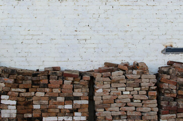 Old bricks against white brick wall