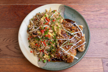 Arroz tapado con huevo en omelette, con pollo frito