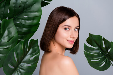 Portrait of lady beautician surround green leaf enjoy pure silky spa salon treatment effect isolated over grey color background