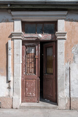 Fototapeta na wymiar Open old shabby wooden front door 