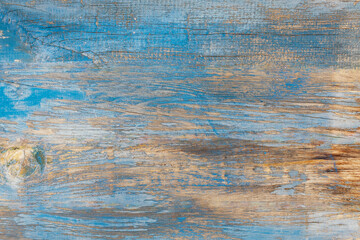 Old wood surface with blue paint remains texture background