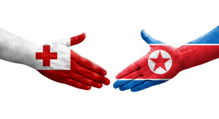 Handshake between North Korea and Tonga flags painted on hands, isolated transparent image.