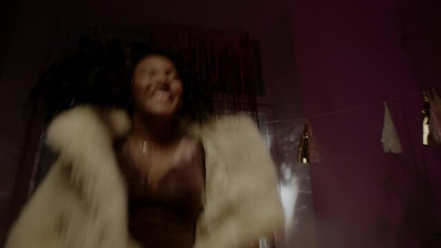 A black girl jumping on the sofa and being happy