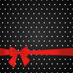 Black polka dot background with red bow © DELYRICA