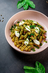 Fusilli pasta with feta cheese, dried peppers and parsley. Shot