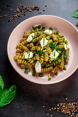 Fusilli pasta with feta cheese, dried peppers and parsley. Shot