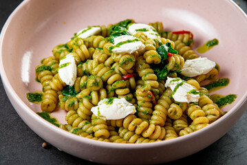 Fusilli pasta with feta cheese, dried peppers and parsley. Shot