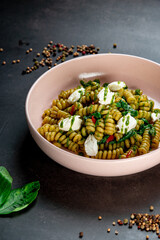 Fusilli pasta with feta cheese, dried peppers and parsley. Shot