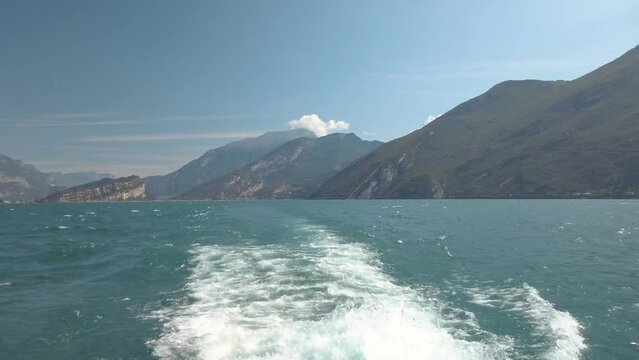 Splashing wake after tourist ferry on Garda lake